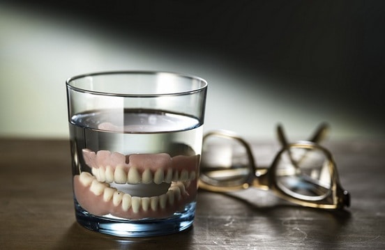 put dentures on glass